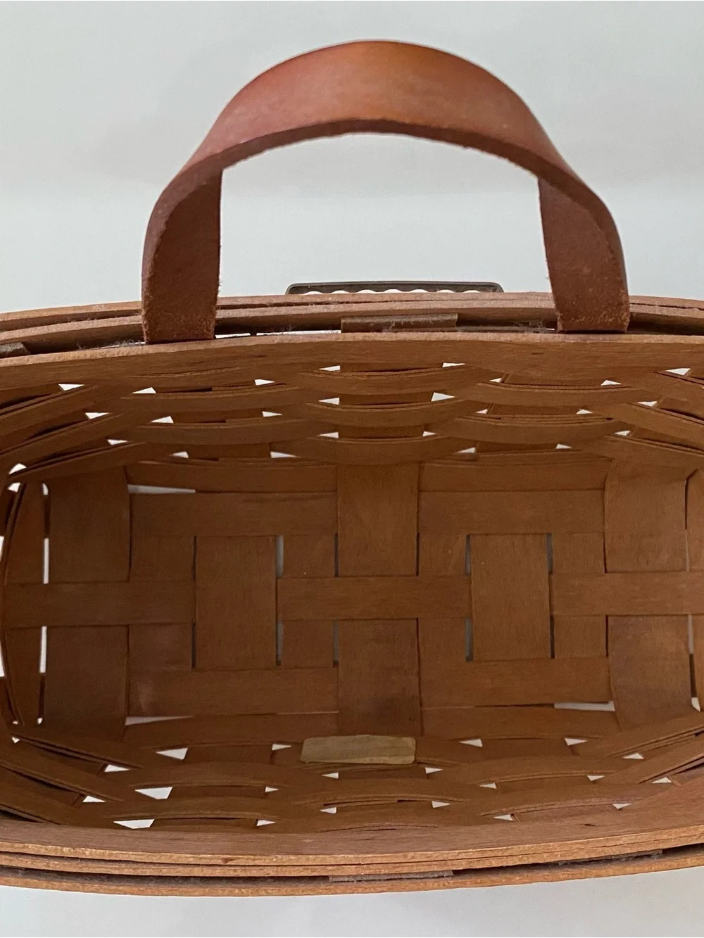 Vintage handwoven Longaberger Medium Key Basket with a leather handle.